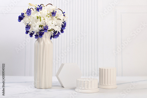 Beautiful banner with hyacinths and muscari in a vase and empty, varied product display stands, design template, and a display. Abstract floral arrangement for a product display business card,