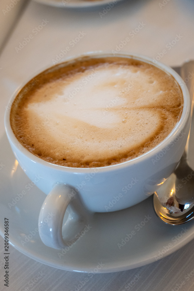 Obraz premium Barista made coffee cappuccino with foam heart with soy milk vegan drink