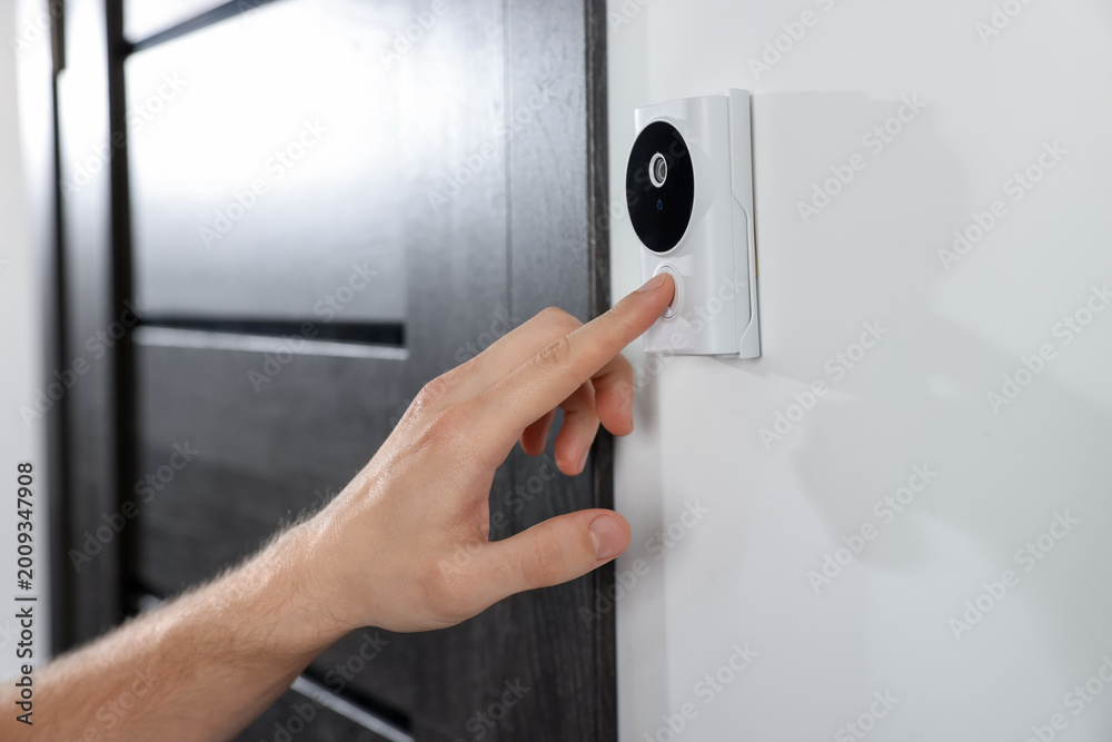 Naklejka premium Man pressing button on intercom panel indoors, closeup