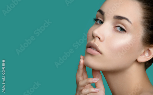 Portrait of beauty model with make-up, formed eyebrows  and long eyelashes. Beautiful young smiling women face with perfect fresh skin. Spa, skincare and wellness. Selective focus. Close-up
