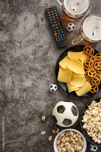 Obraz na płótnie Football championship game night with snack and beer and soccer ball on vertical