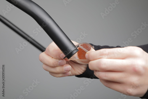 Quadro su tela Person's hands installing a transparent silicone chair leg protector with a felt