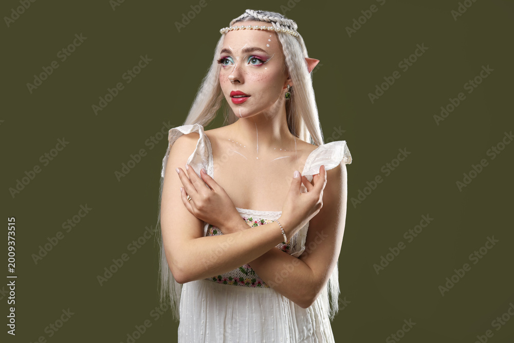 Fototapeta premium Beautiful elf girl on dark olive background
