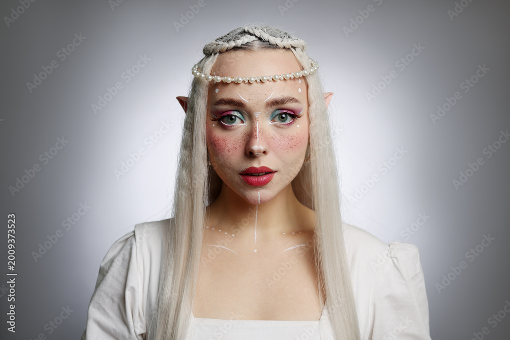 Fototapeta premium Beautiful elf girl on grey gradient background
