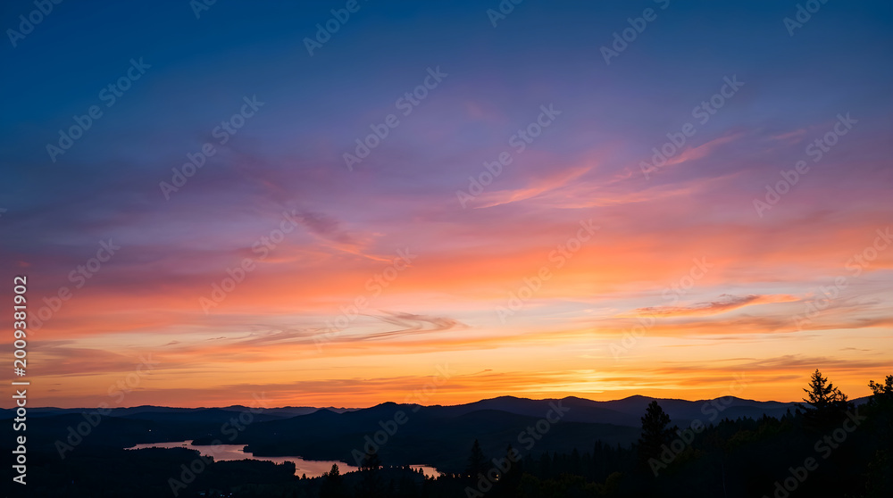 Fototapeta premium Sunset over mountains and lake