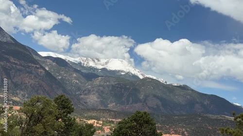 A stunning time-lapse of Pikes Peak covered in snow, with close-up views of the mountain and beautiful flowing clouds. Garden of the Gods, Colorado Springs, Colorado