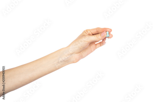 Foto Push pins in hand isolated on white background.
