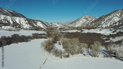 Aerial view of Grass Valley and Hogback Ridge in Garfield County, Colorado after heavy snowfall on cold clear February morning 4K.