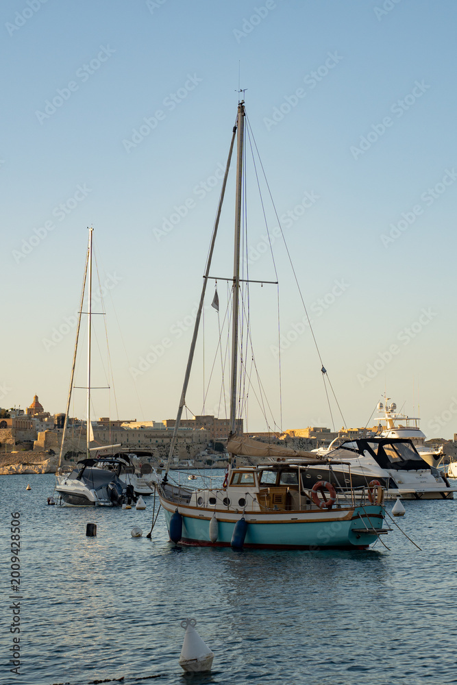 Fototapeta premium Luxury yachts and sailing boats moored in the historic yacht marina of Valletta Grand Harbour Malta 
