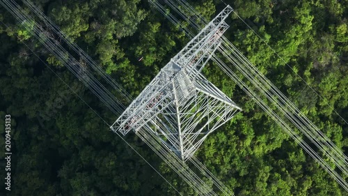 Aerial footage of High voltage line tower on mountain