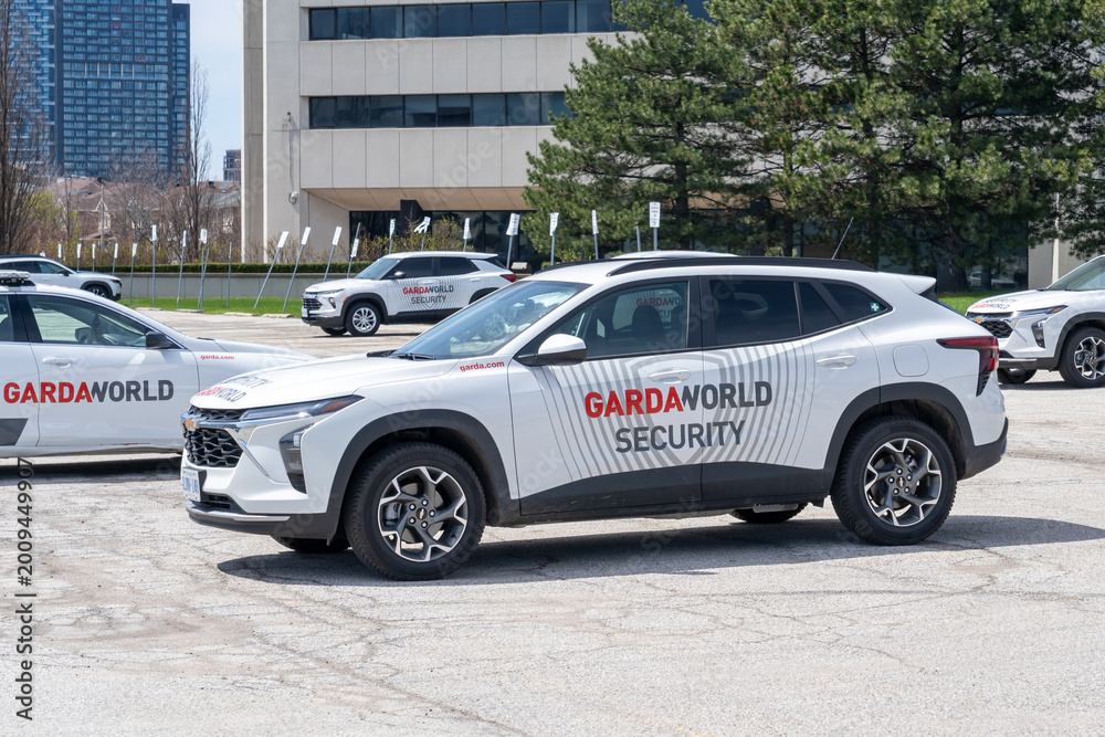 Naklejka premium Toronto, Canada - April 26, 2026: GardaWorld vehicles parked outside its office in Toronto, Canada. GardaWorld Corporation is a Canadian private security firm.