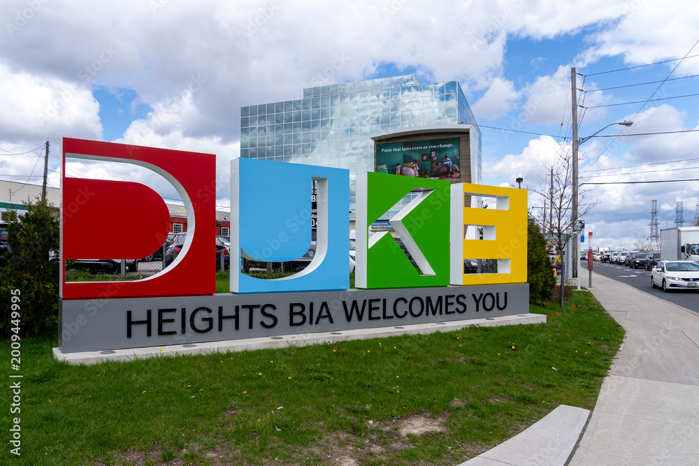 Fototapeta premium Toronto, Canada - May 1, 2026: The DUKE Heights Business Improvement Area (BIA) welcome ground sign located on Finch Avenue in North York, Ontario, Canada, featuring large, colorful letters. BIA is a