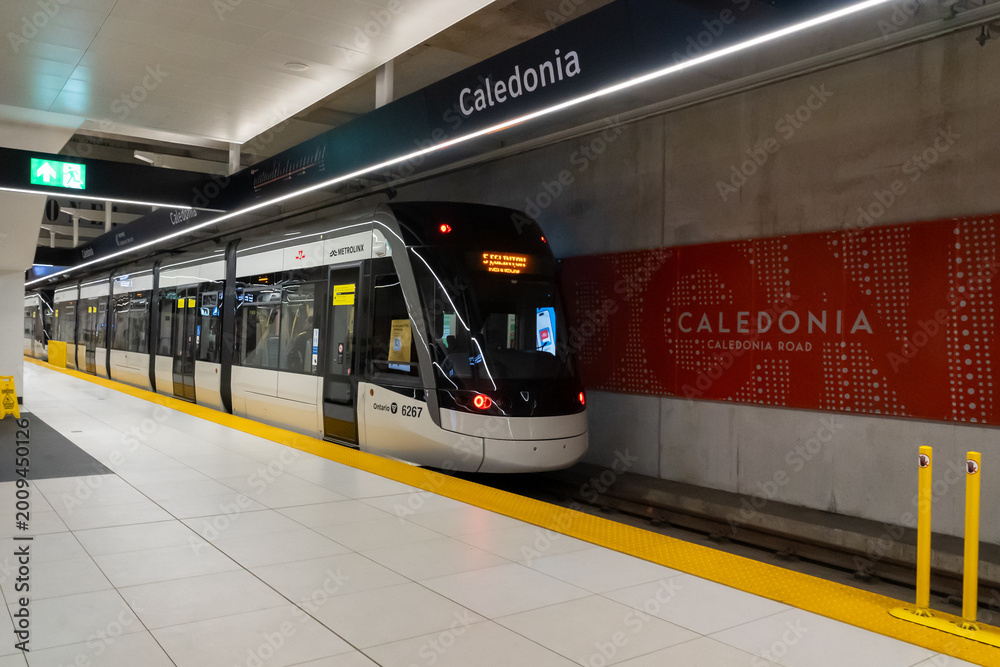 Naklejka premium Toronto, ON, Canada - May 4, 2026: A Flexity Freedom train at Caledonia Station on the Eglinton Crosstown LRT (Line 5 Eglinton) in Toronto, ON, Canada, in 2026. The Eglinton Crosstown LRT is a new rap