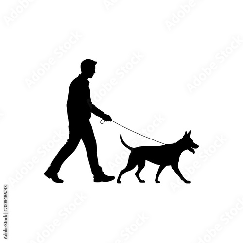 silhouette of a man walking with his dog