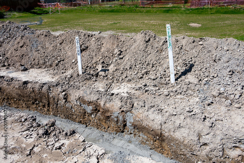 Fotografija Residential development construction site, trench excavated in ground for underg