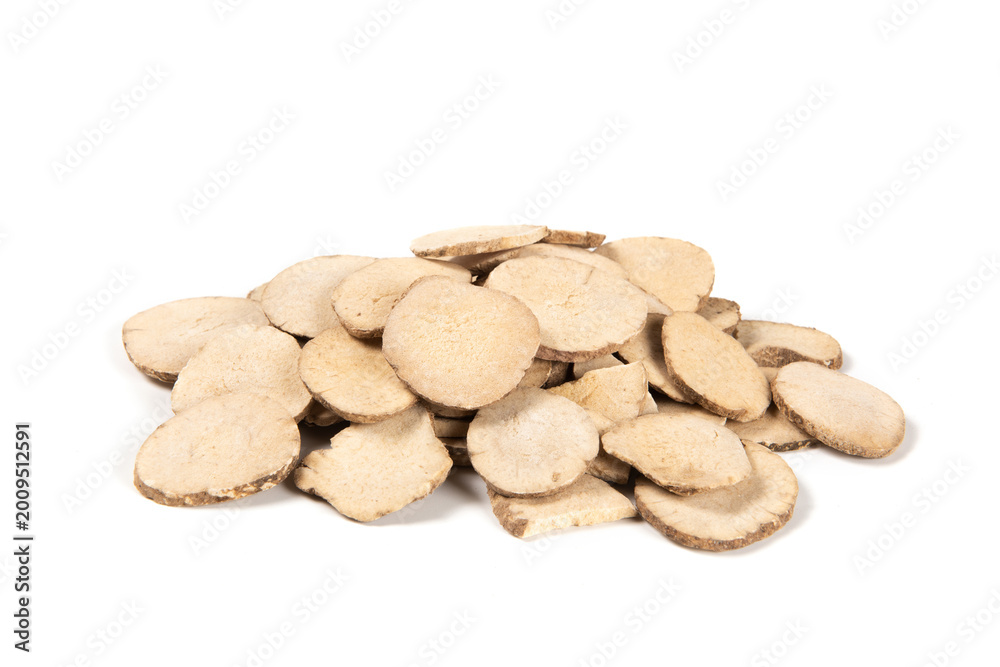 Fototapeta premium Dried white peony root slices pile on white background