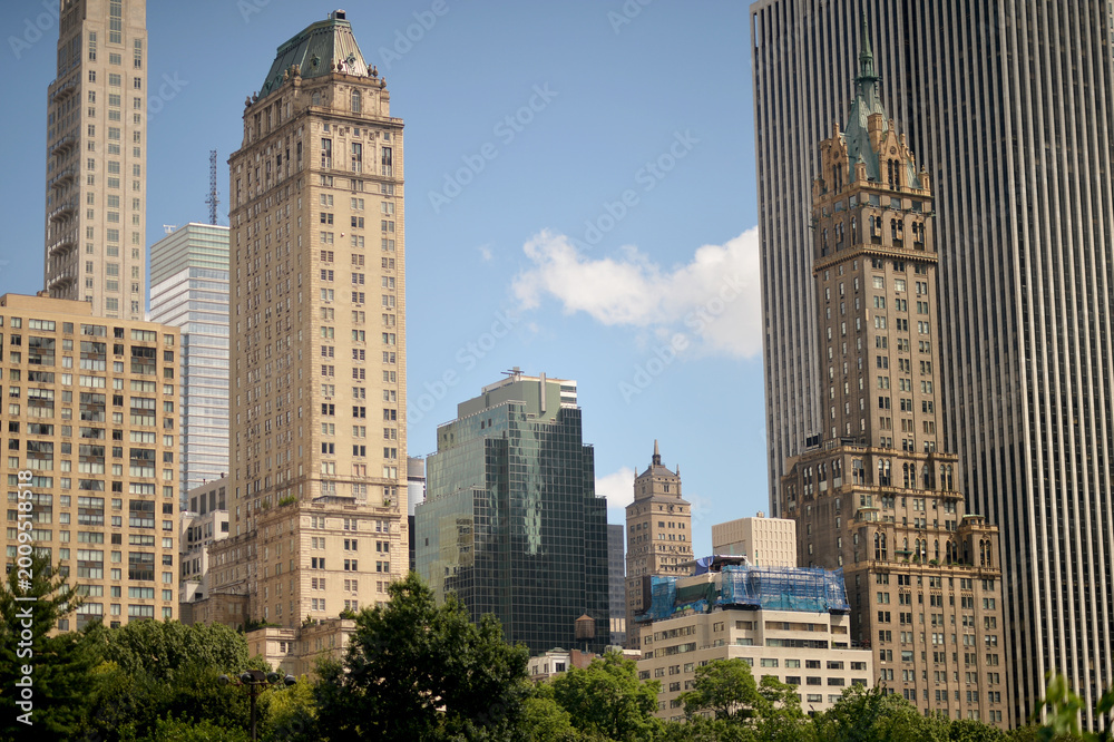 Fototapeta premium Skyline Composed Of Historic Towers And Modern Glass Structures Illuminated At Midday new york