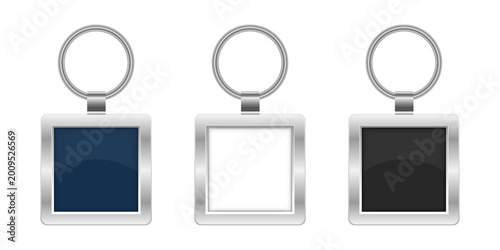 Canvastavla A trio of square keychains with metal rings and colorful inserts on white