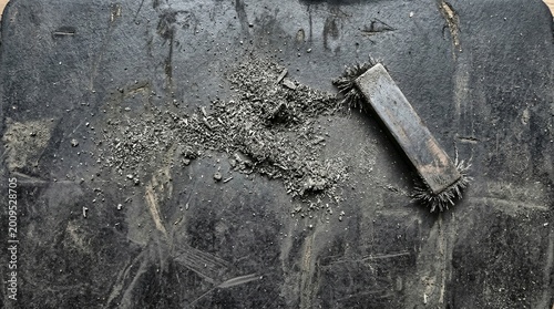 Magnet and Iron Filings on Dark Textured Surface