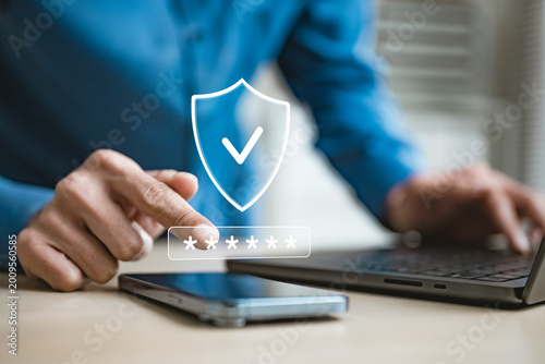 Foto User entering password on smartphone with shield icon and secure login interface, representing OTP verification, MFA authentication, cybersecurity, identity protection, encrypted mobile access