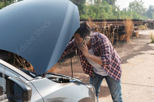 Roadside assistance, broken down car tired man