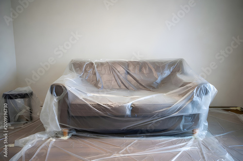 Sofa Covered In Plastic Sheeting For Painting Protection