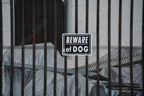 Φωτογραφία Beware of Dog sign attached to a metal security fence