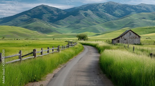 Serene Rural Landscape with Rolling Green Hills and Rustic Barn Under a Clear Blue Sky