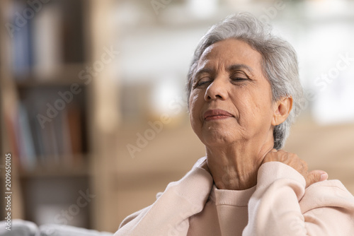 Картината върху платно Senior woman feeling severe neck pain holding tight shoulder muscle suffering ph