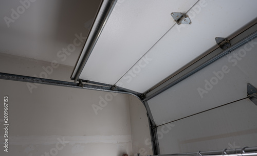 Close up view of Garage Doors opening. View from Inside in garage. 