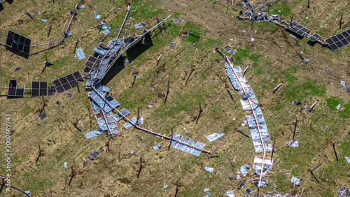 Aerial shoot of a solar energy field destroyed by a tornado with broken panels scattered across the ground.