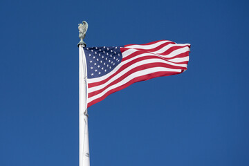 Flag American waving in blue horizon. American patriotic banner on liberty flag. USA democracy freedom symbol in flag. American independence culture on flag.