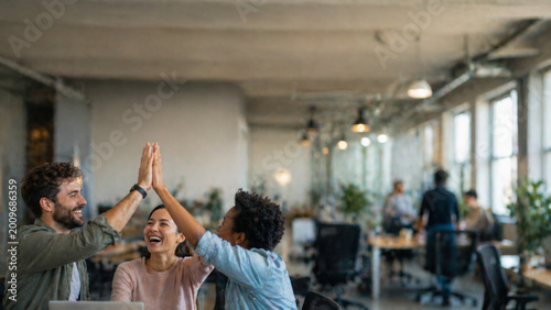 Happy colleagues high five office team