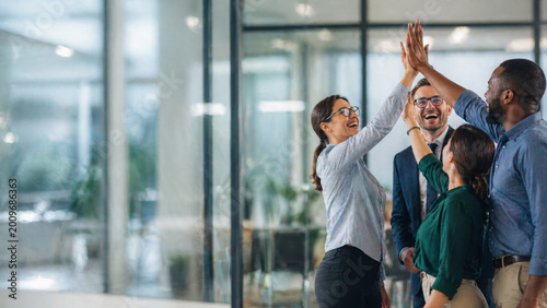 Diverse business team high five celebrating success