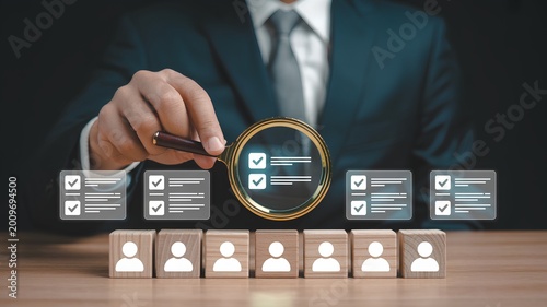Strategic candidate selection Professional reviewing profiles with a magnifying glass for optimal talent acquisition and human resource management