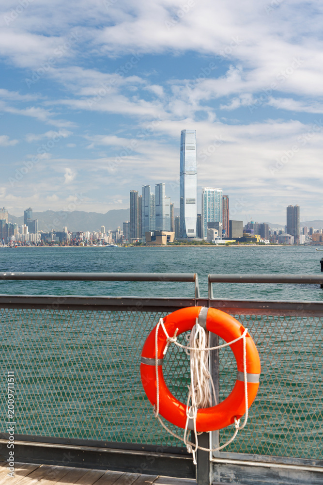 Fototapeta premium Hong Kong skyscraper panorama on a sunny day with water and boats