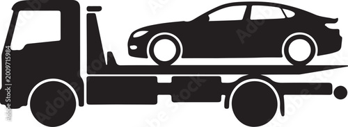 Foto Flatbed tow truck carrying car on road