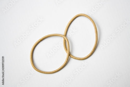 Cream hair ties on white background. Hair accessory