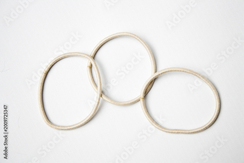 Cream hair ties on white background. Hair accessory