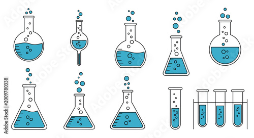 Large collection of various laboratory glassware items like beakers and flasks filled with bubbling blue liquid used for scientific experiments.