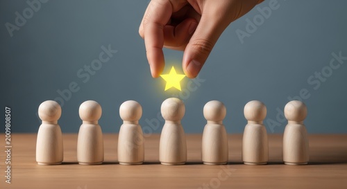 Hand placing a glowing yellow star above a wooden figure in a row of similar figures