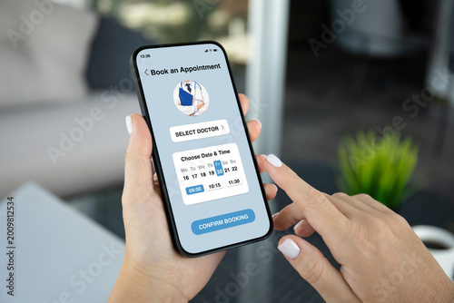 woman holding phone with medical doctor appointment booking app interface