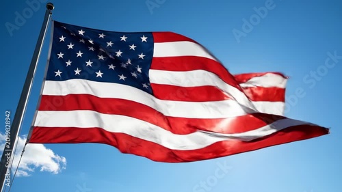American flag waving proudly against bright blue sky