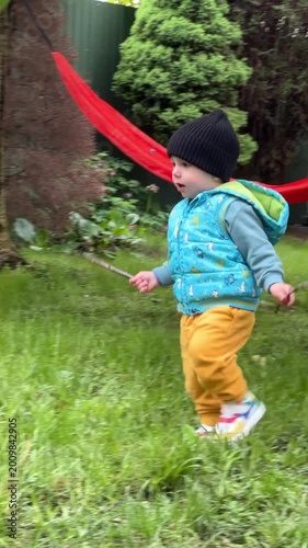 Toddler Chasing Soap Bubble in Green Backyard Garden