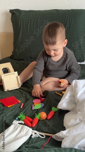 Toddler Playing With Wooden Shape Sorter and Toy Vegetables