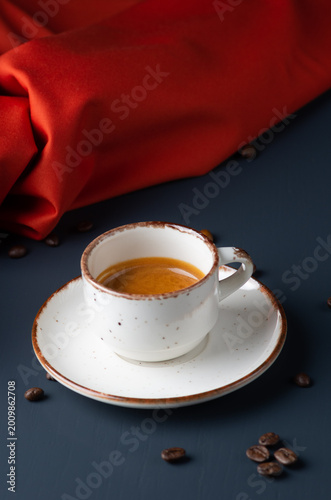 White cup of espresso coffee on background.