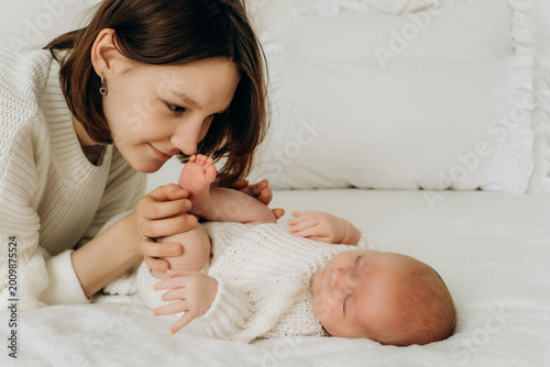 mother with a newborn baby, mother gently kisses and hugs a small child, mother and baby, motherhood