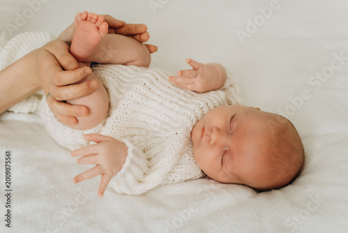 a newborn baby is sleeping, a sweet healthy baby's sleep on a white bed, space and room for text