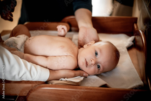 baptism of a child, a baby in a church or cathedral, dipping a child in water in a font
