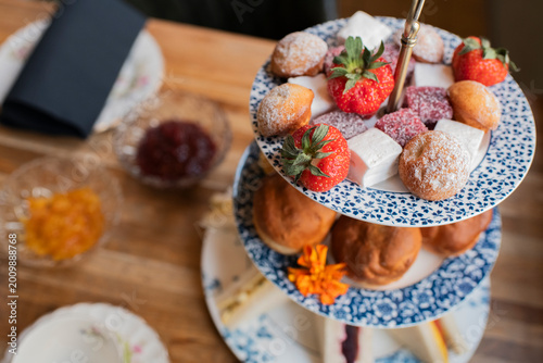 Tableau sur toile Close up of afternoon tea desserts with strawberries and pastries